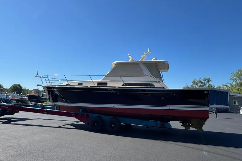 Slide: The Image of 2008 Sabre 38 Hardtop Express boat on trailer under clear blue sky. - 5