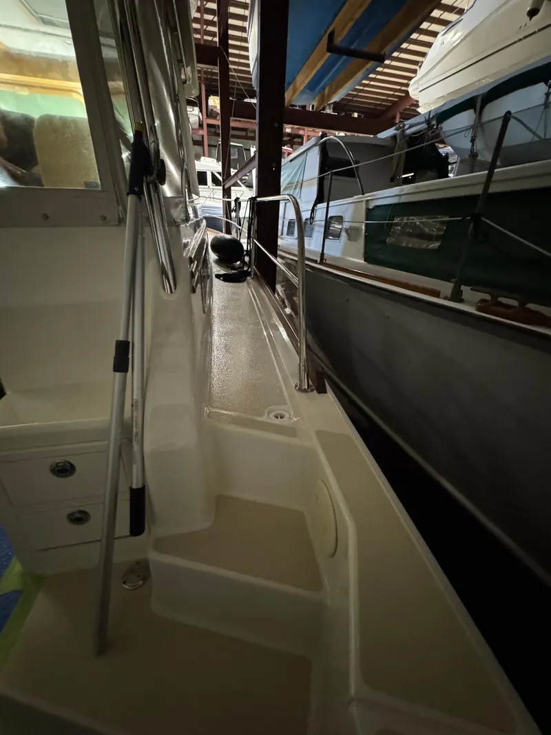 Slide: The Image of 2008 Sabre 38 Hardtop Express boat docked in a marina, side view. - 50