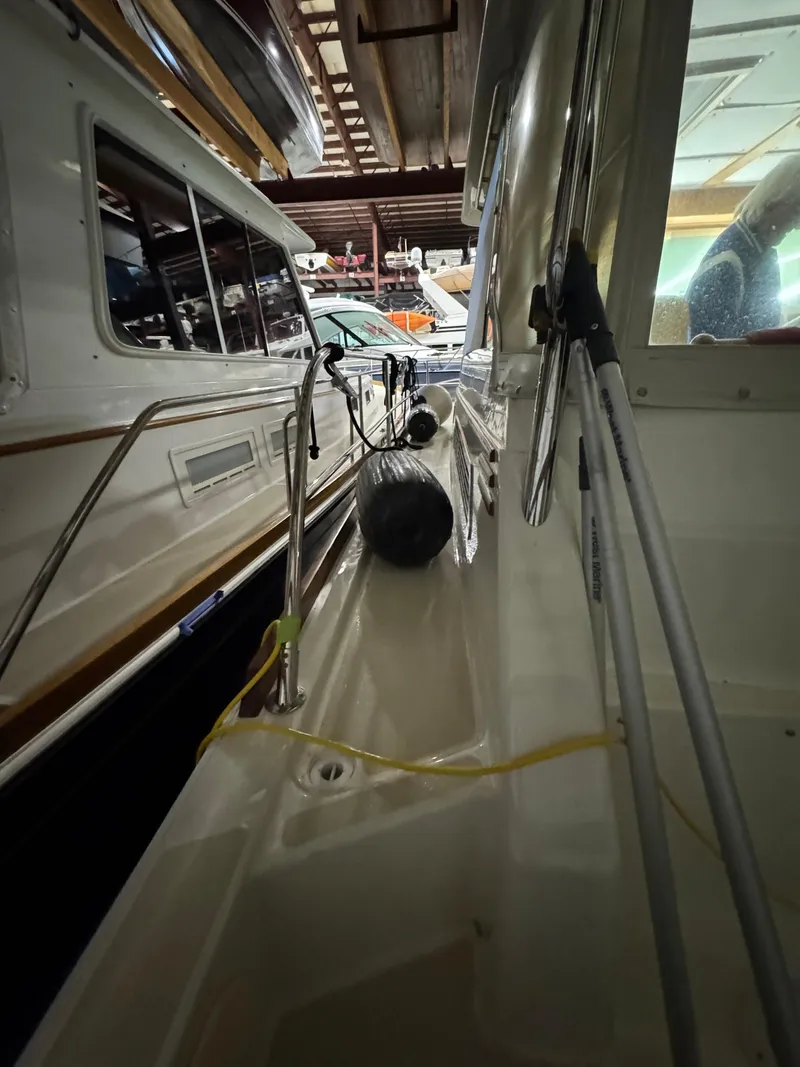 Slide: The Image of 2008 Sabre 38 Hardtop Express in storage, side view with fenders and railings. - 51