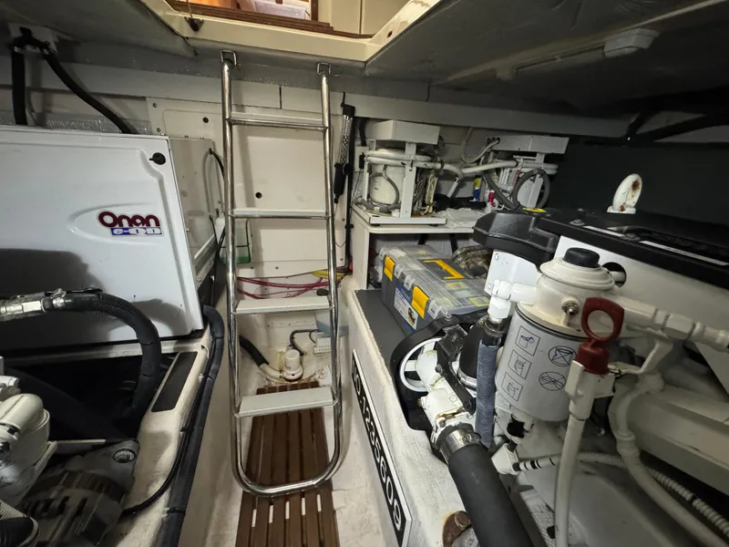 Slide: The Image of Engine room of 2008 Sabre 38 Hardtop Express with Onan generator and mechanical components. - 59