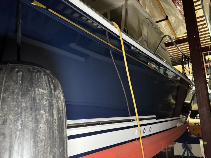 Slide: The Image of 2008 Sabre 38 Hardtop Express boat in storage, featuring a sleek blue hull. - 78