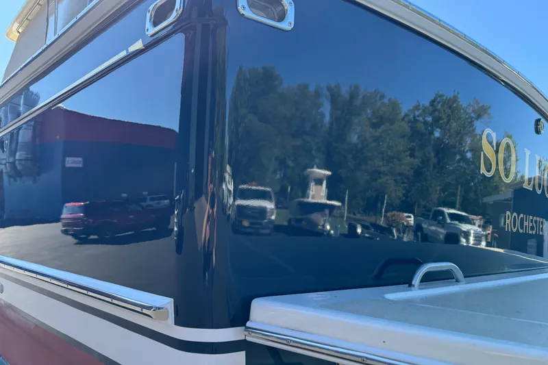 Slide: The Image of 2008 Sabre 38 Hardtop Express boat with reflective blue hull in a marina setting. - 8