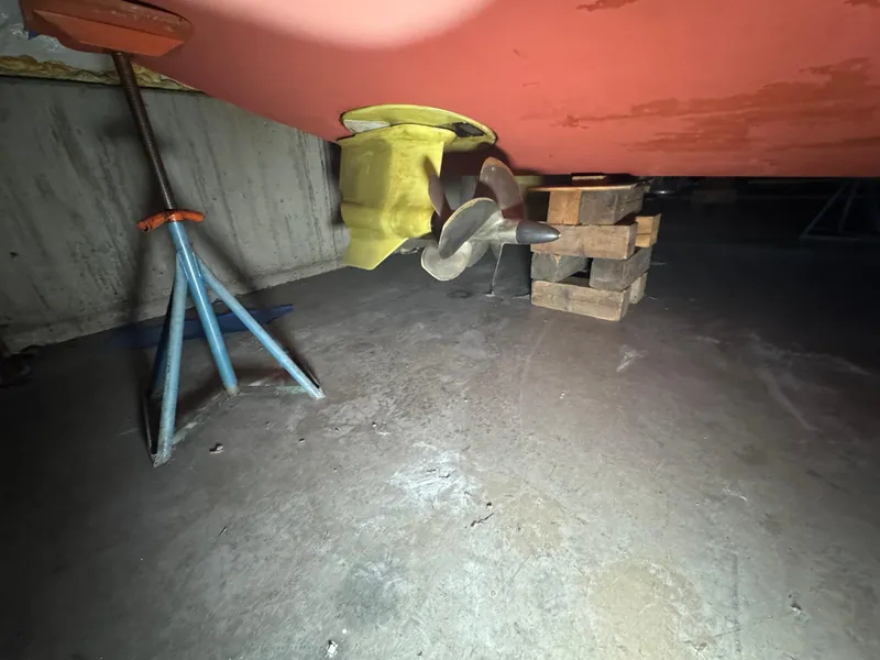 Slide: The Image of 2008 Sabre 38 Hardtop Express propeller and hull on support blocks in a workshop. - 82