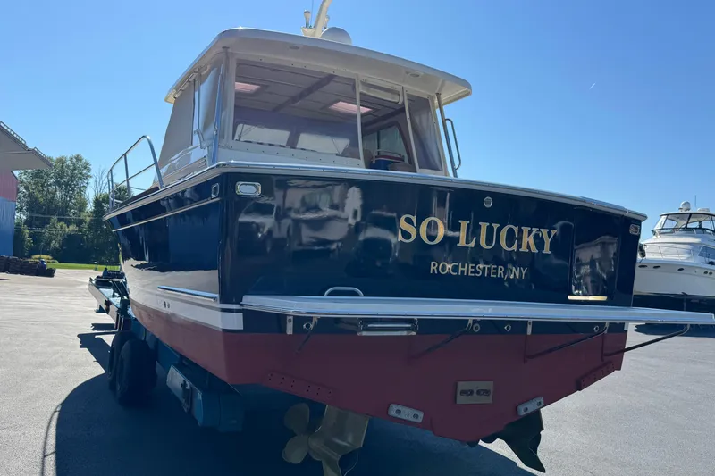 Slide: The Image of 2008 Sabre 38 Hardtop Express boat named "So Lucky" in Rochester, NY, on a trailer. - 9