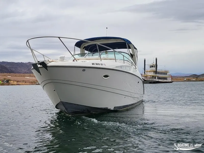 Slide: The Image of 2008 Bayliner 300SB boat cruising on a lake with a paddle steamer in the background. - 10