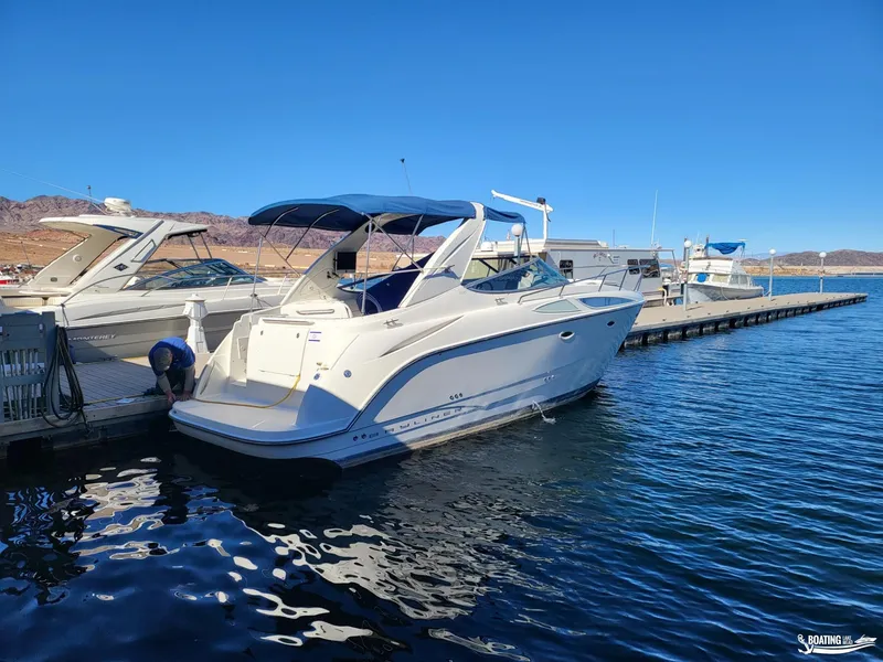 Slide: The Image of 2008 Bayliner 300SB docked at marina under clear blue sky. - 13