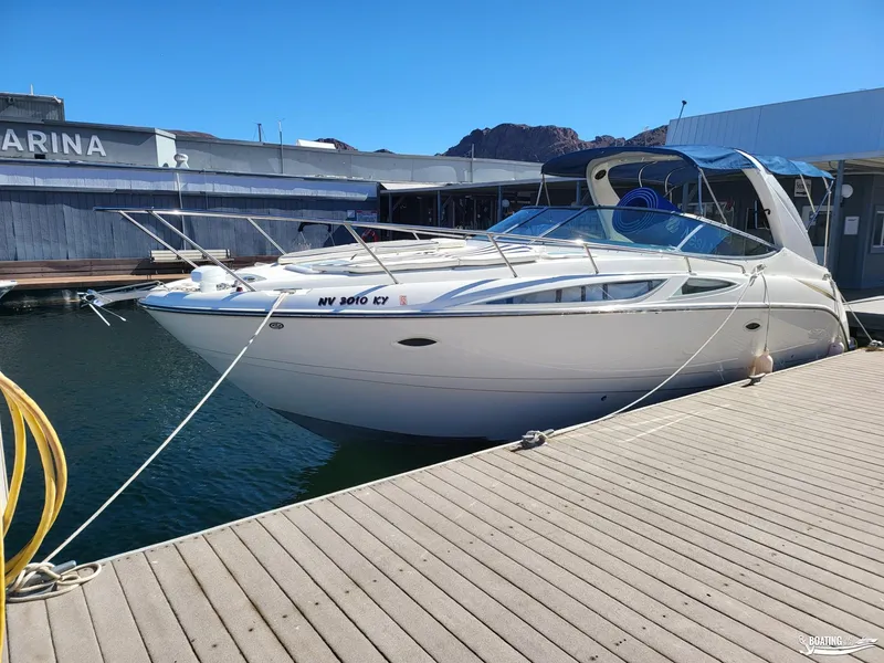 Slide: The Image of 2008 Bayliner 300SB boat docked at marina under clear blue sky. - 14