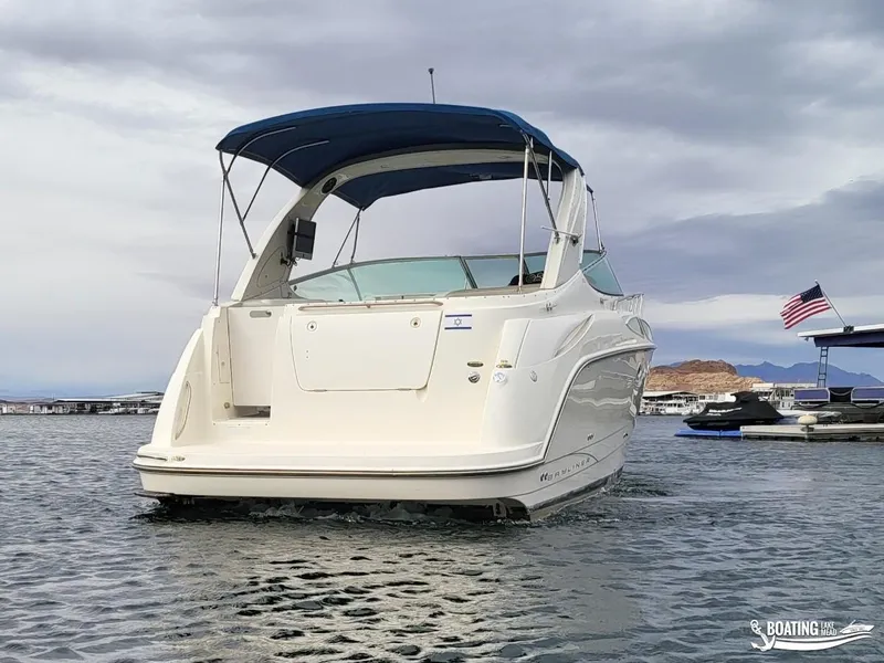Slide: The Image of 2008 Bayliner 300SB boat with blue canopy on a lake, cloudy sky background. - 3