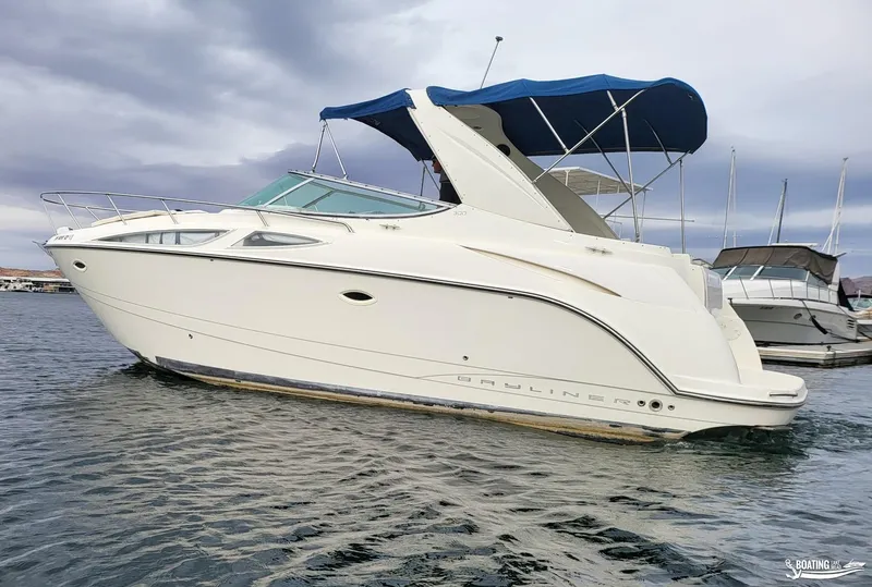 Slide: The Image of 2008 Bayliner 300SB boat with blue canopy on calm water. - 5