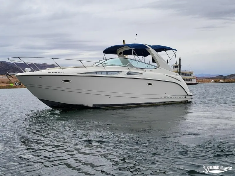 Slide: The Image of 2008 Bayliner 300SB boat on calm water with overcast sky. - 8