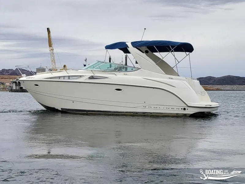 Slide: The Image of 2008 Bayliner 300SB boat with blue canopy on calm water. - 9