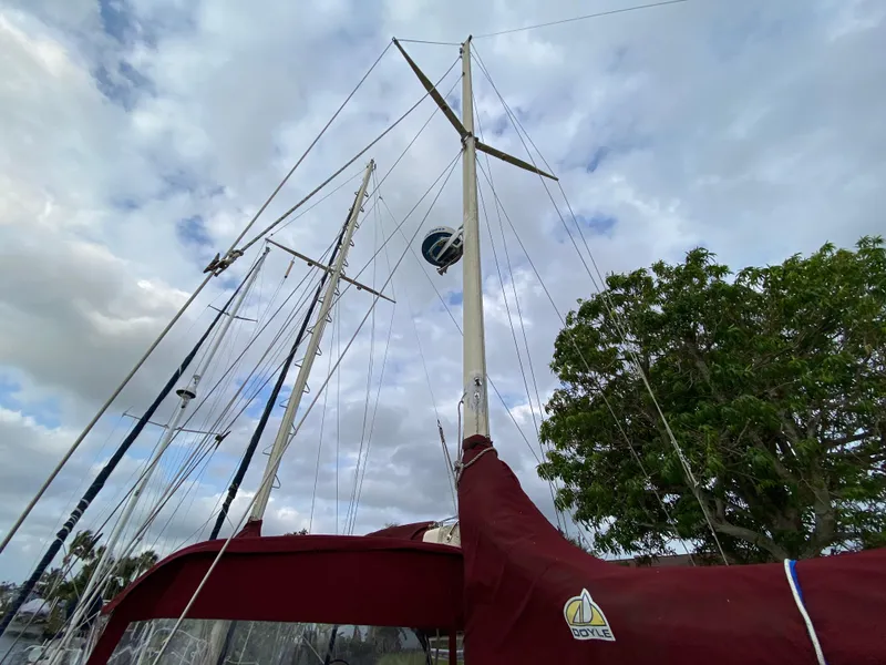 Slide: The Image of Outdoor grill on Bruce Roberts 43 Ketch, 1986, docked by a canal with houses nearby. - 19