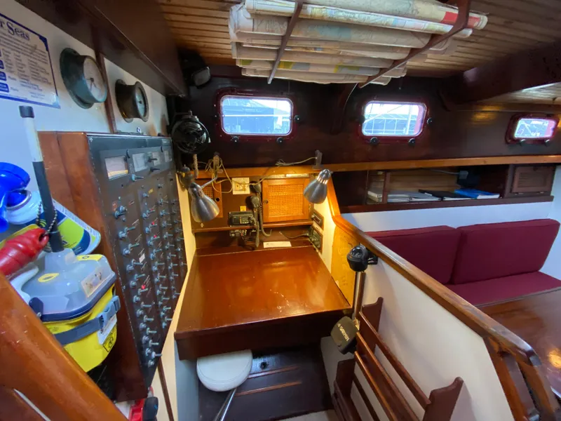 Slide: The Image of 1986 Bruce Roberts 43 Ketch cockpit with steering wheel, ropes, and seating under maroon canopy. - 26