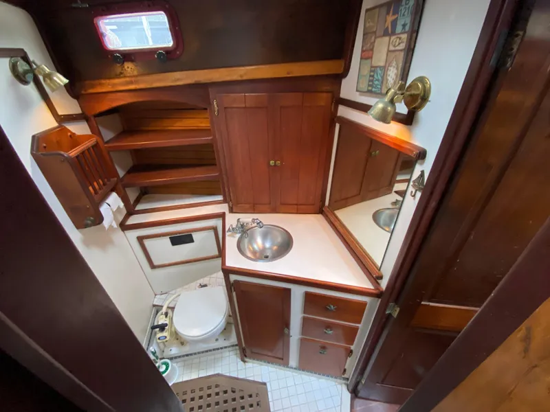 Slide: The Image of 1986 Bruce Roberts 43 Ketch interior view through wooden hatch, showcasing nautical craftsmanship. - 29