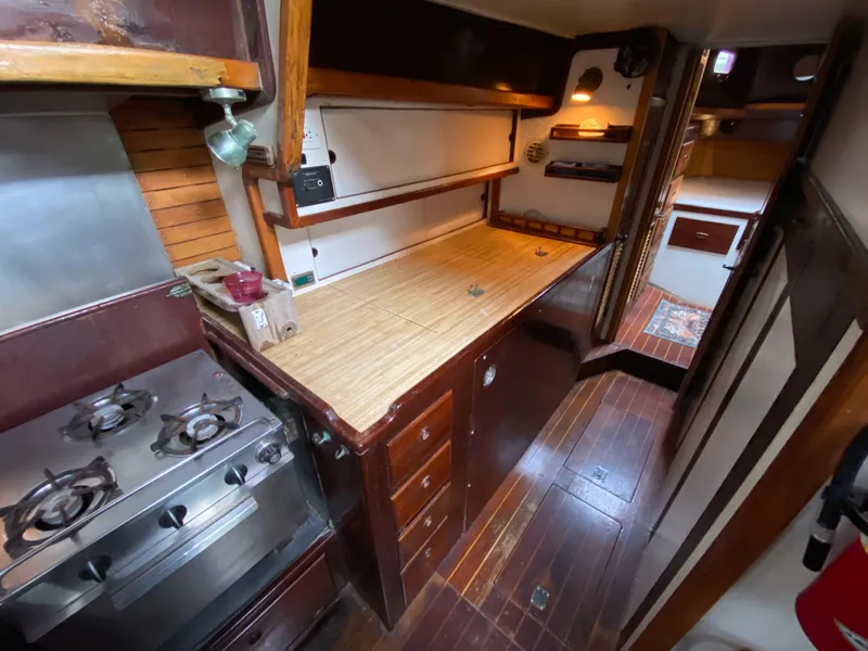 Slide: The Image of 1986 Bruce Roberts 43 Ketch interior with navigation station and cozy seating area. - 33
