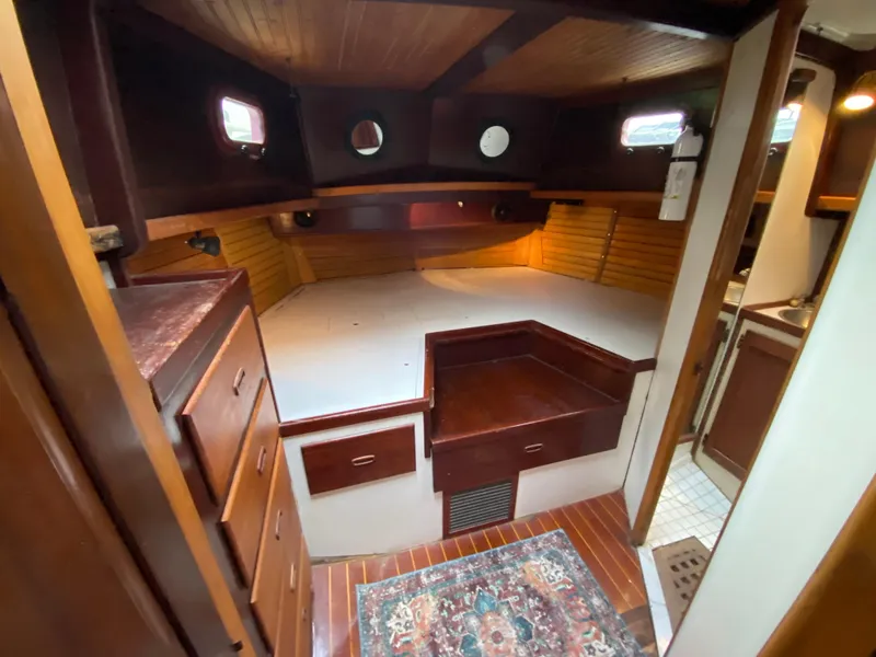 Slide: The Image of Interior of 1986 Bruce Roberts 43 Ketch, featuring cozy seating and wooden accents. - 36