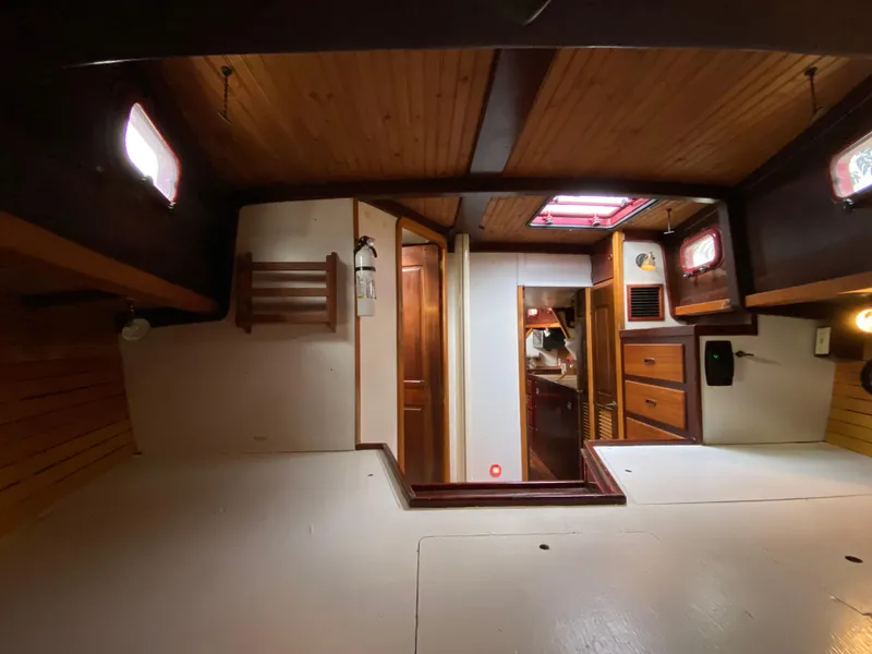 Slide: The Image of Empty wooden compartment on 1986 Bruce Roberts 43 Ketch sailboat, showing number 1090324. - 41