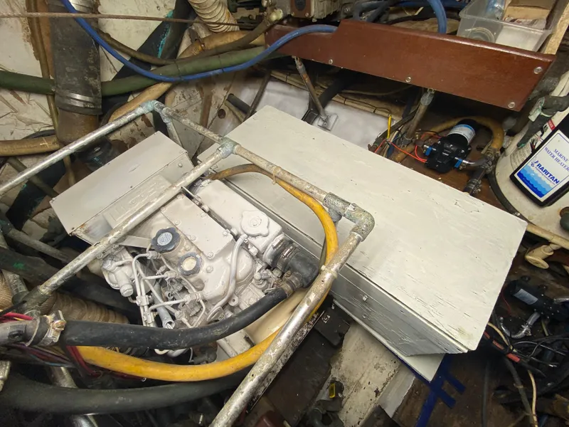 Slide: The Image of Interior of 1986 Bruce Roberts 43 Ketch, featuring wood paneling and compact bathroom. - 44