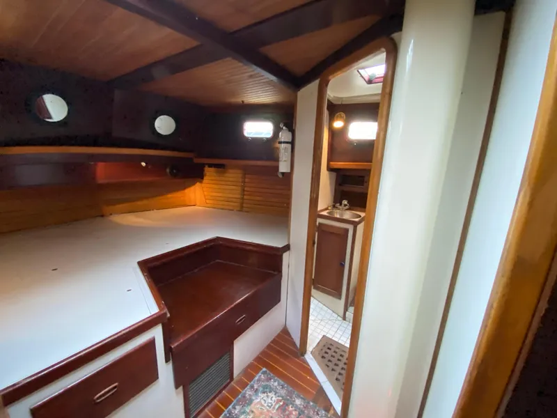 Slide: The Image of Interior of 1986 Bruce Roberts 43 Ketch, featuring cozy cabin and compact bathroom. - 49