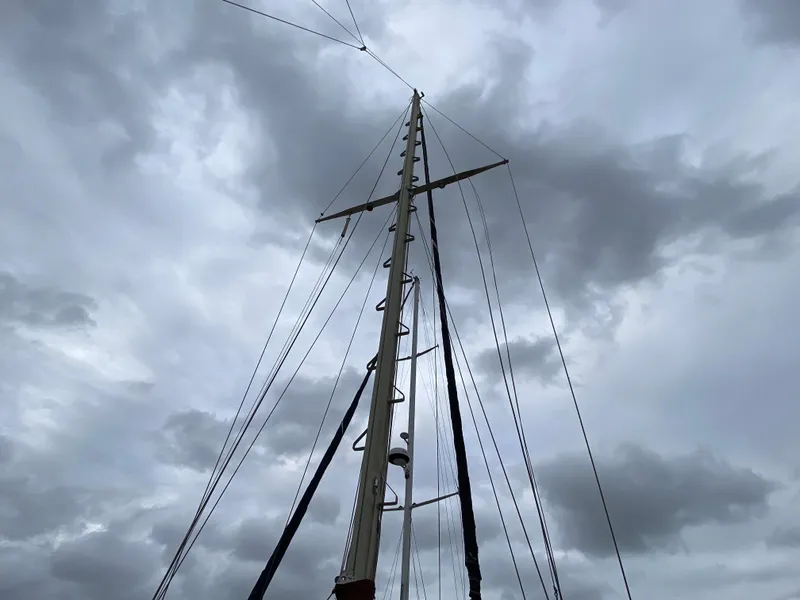 Slide: The Image of Anchor setup on 1986 Bruce Roberts 43 Ketch sailboat, docked near garden area. - 9