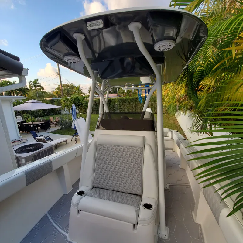 Slide: The Image of 1976 Formula 233 boat interior with seating and canopy, surrounded by lush greenery. - 11