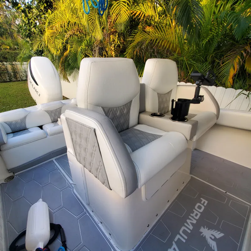 Slide: The Image of Luxury seating on a 1976 Formula 233 boat, surrounded by lush greenery. - 13