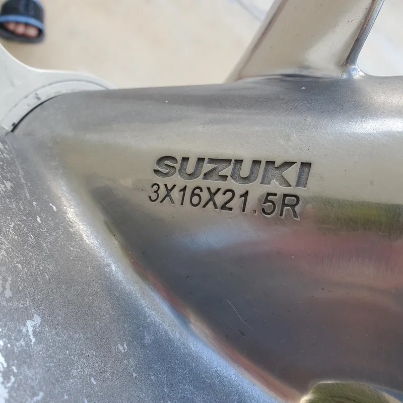Slide: The Image of Close-up of a Suzuki propeller with model number 3X16X21.5R, metallic finish. - 17