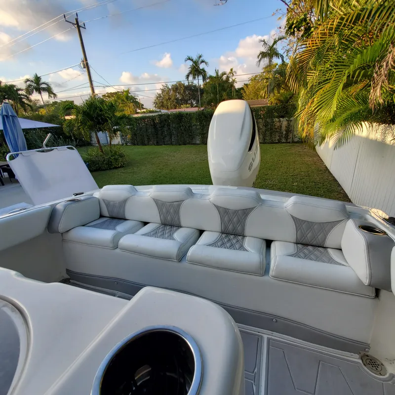 Slide: The Image of 1976 Formula 233 boat interior with white seating and outdoor view. - 3