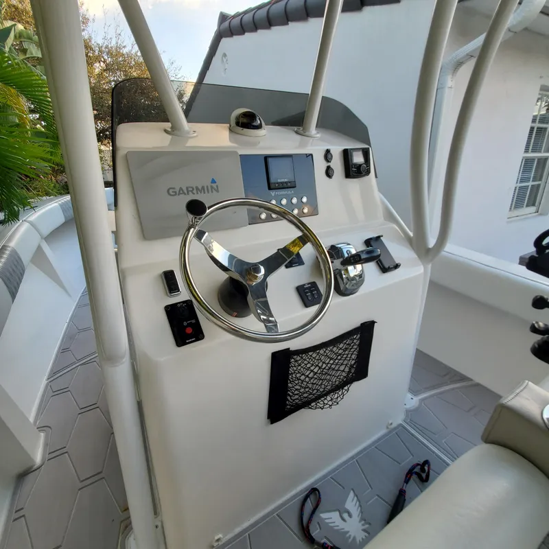 Slide: The Image of 1976 Formula 233 boat helm with Garmin navigation system and steering wheel. - 5