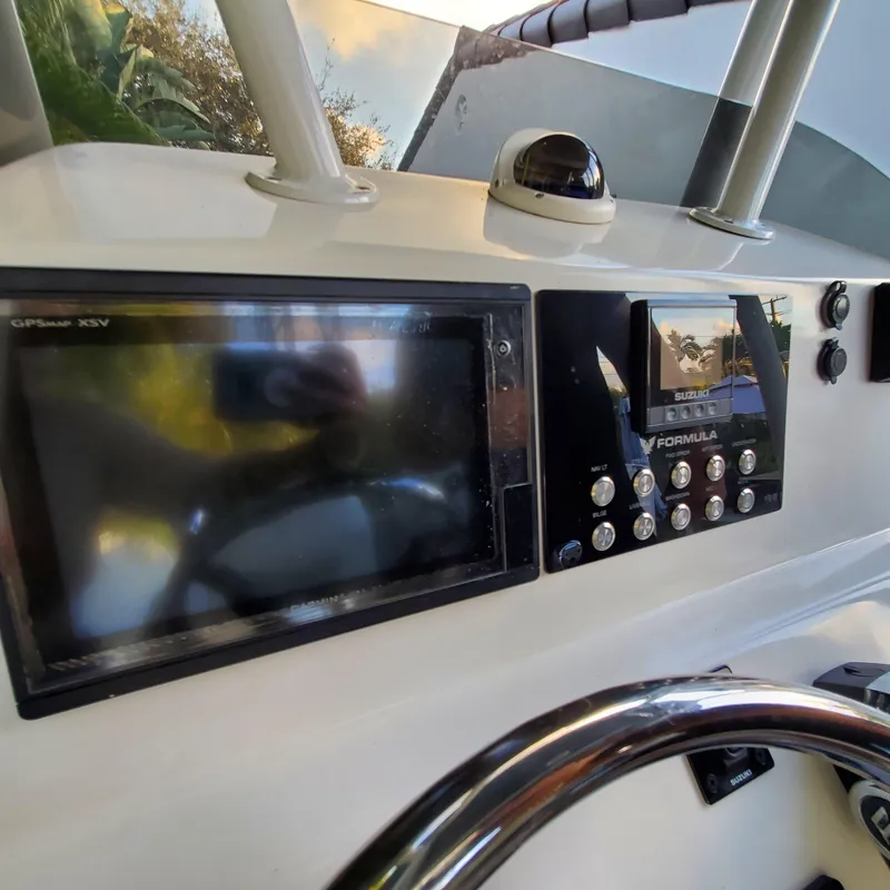 Slide: The Image of Dashboard of a 1976 Formula 233 boat with navigation and control panels. - 6
