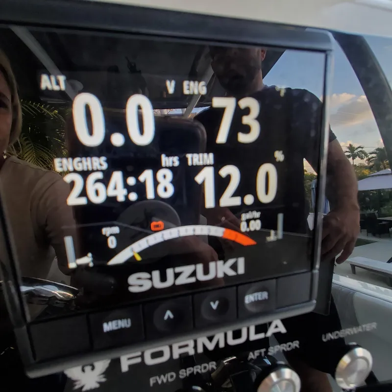 Slide: The Image of Suzuki engine display on a 1976 Formula 233 boat, showing engine hours and trim. - 8
