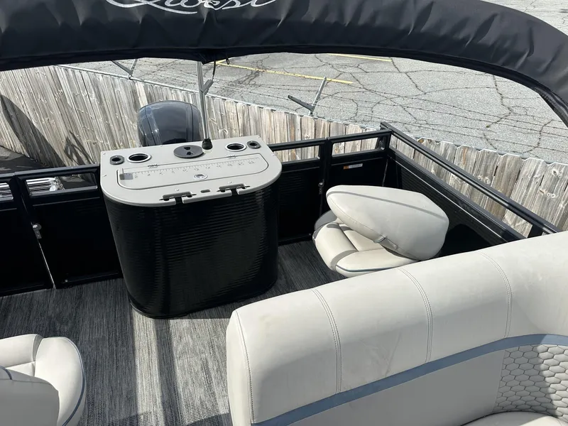 Slide: The Image of 2023 Qwest Pontoons XRE Cruise 22 interior with seating and control panel. - 12