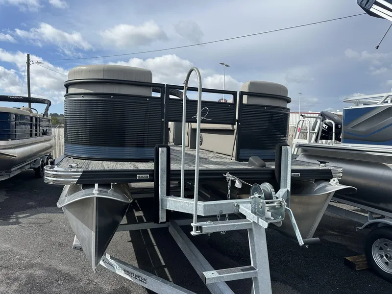 Slide: The Image of 2023 Qwest Pontoons XRE Cruise 22 on trailer, ready for fishing and cruising. - 2