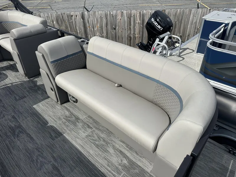 Slide: The Image of 2023 Qwest Pontoons XRE Cruise 22 interior with gray seating and Suzuki outboard motor. - 4