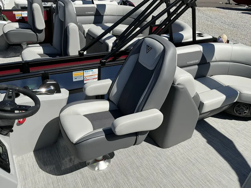 Slide: The Image of 2025 Viaggio Lago V 22U boat interior with gray seating and steering console. - 6