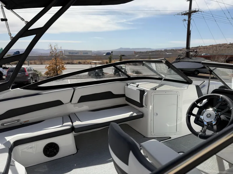Slide: The Image of 2025 Yamaha Boats AR195 interior with sleek seating and modern steering wheel design. - 16