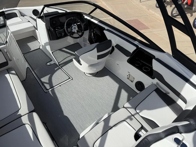 Slide: The Image of 2025 Yamaha Boats AR195 interior with modern seating and sleek dashboard design. - 23