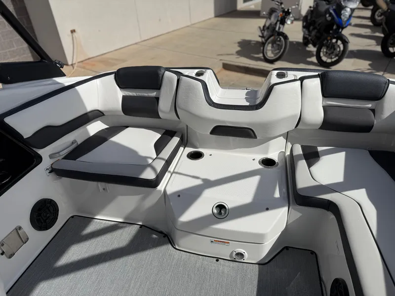 Slide: The Image of 2025 Yamaha Boats AR195 interior with cushioned seating and storage compartments. - 26