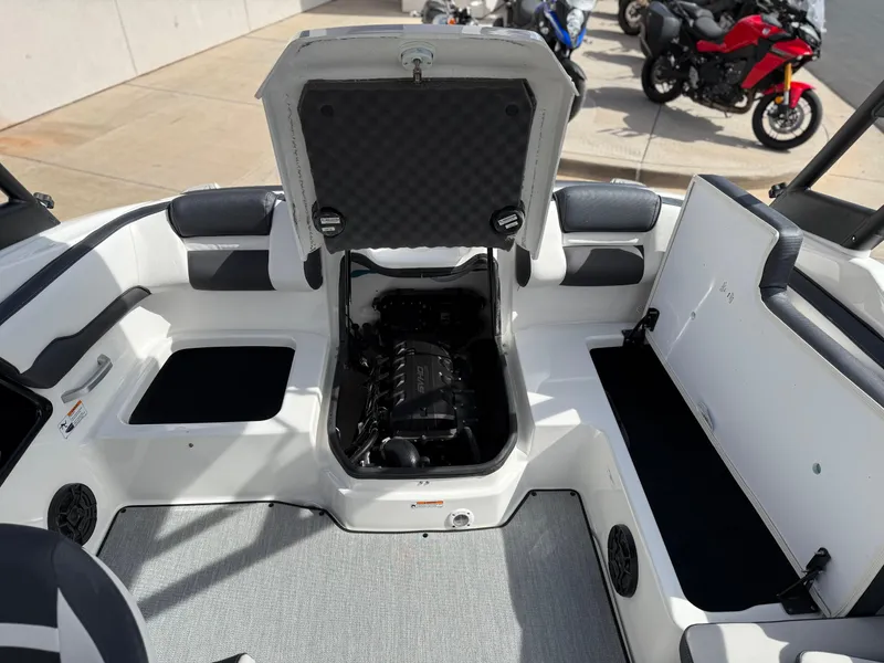 Slide: The Image of 2025 Yamaha Boats AR195 interior with open engine compartment, showcasing sleek design and seating. - 27