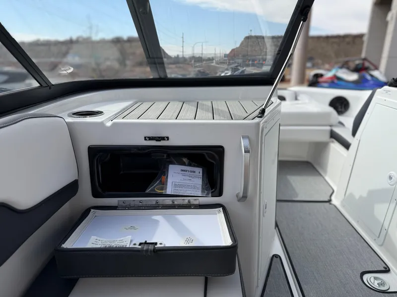 Slide: The Image of 2025 Yamaha Boats AR195 interior with open storage compartment and sleek design. - 33