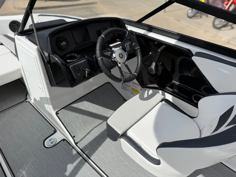 Slide: The Image of 2025 Yamaha Boats AR195 cockpit with sleek steering wheel and modern dashboard design. - 37