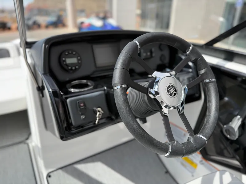 Slide: The Image of 2025 Yamaha Boats AR195 steering wheel and dashboard, featuring modern controls and sleek design. - 38
