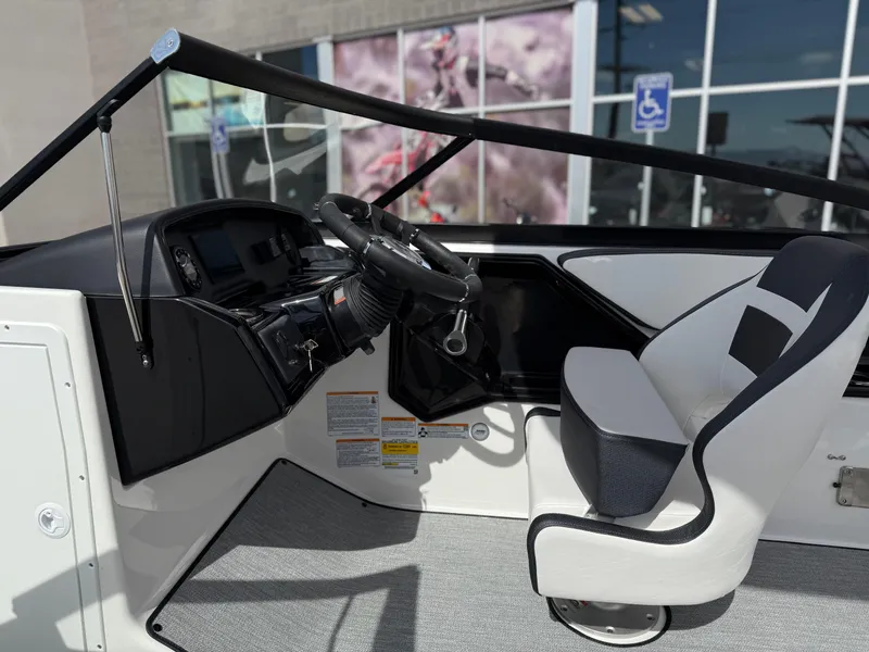 Slide: The Image of 2025 Yamaha Boats AR195 interior with steering wheel and captain's chair. - 41