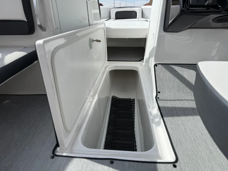 Slide: The Image of 2025 Yamaha Boats AR195 interior storage compartment, open and spacious design. - 46