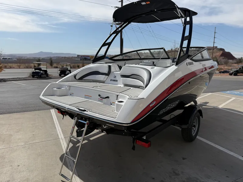 Slide: The Image of 2025 Yamaha Boats AR195 on trailer, rear view with swim platform and ladder. - 7