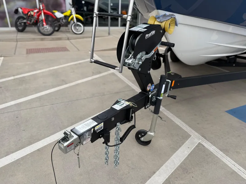 Slide: The Image of Trailer hitch of a 2025 Yamaha Boats AR220, parked with motorcycles in the background. - 20