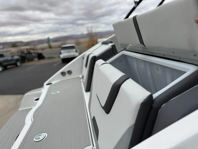 Slide: The Image of 2025 Yamaha Boats AR220 with open storage compartments, showcasing sleek design and functionality. - 22