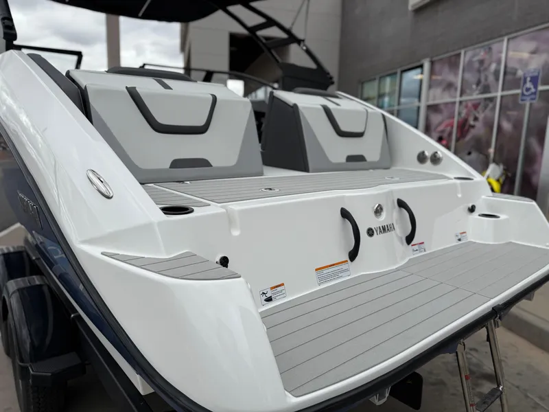 Slide: The Image of 2025 Yamaha Boats AR220, sleek design, rear view, modern seating, outdoor display. - 23