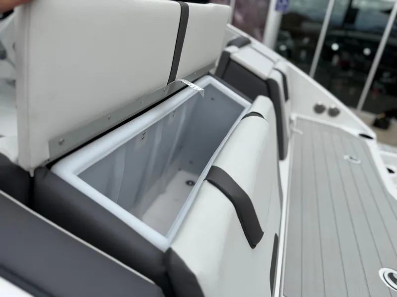 Slide: The Image of 2025 Yamaha Boats AR220 storage compartment with open cushioned seat. - 24