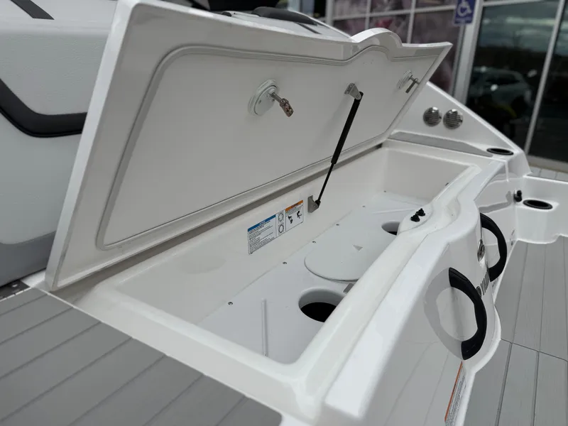 Slide: The Image of Open storage compartment on 2025 Yamaha Boats AR220, showcasing interior features and design. - 25